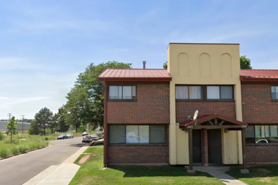 Google street view of two-story brick and stucco apartment building in Sun Valley neighborhood of Denver, Colorado.